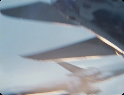 a close up of a plane flying in the sky