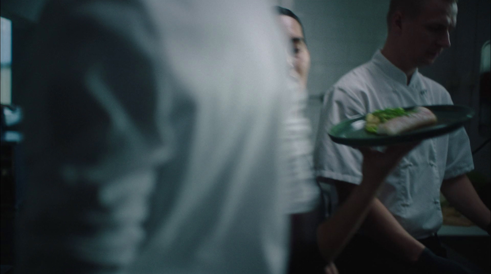 a man holding a plate with food on it