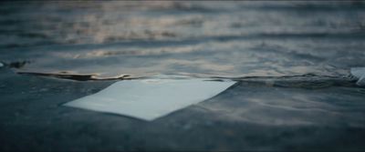 a piece of paper floating on top of a body of water