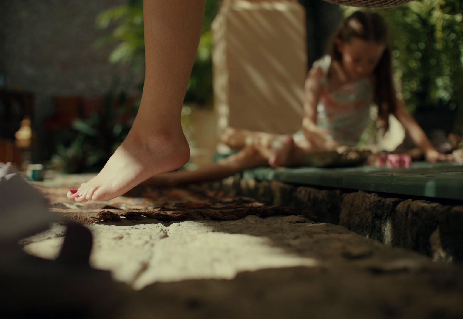 a woman standing over a woman laying on the ground