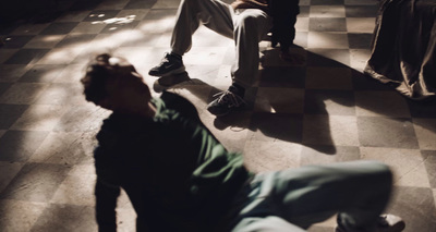 a group of young men sitting on top of a checkered floor