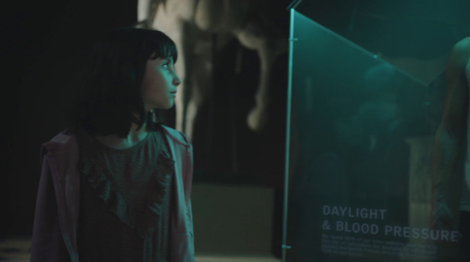 a woman standing in front of a display case