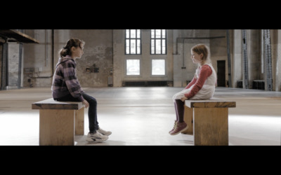 a couple of women sitting on top of wooden benches