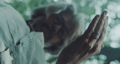 an old man with a ring on his finger