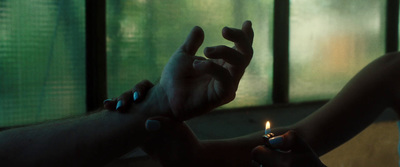 a person holding a lit candle in their hand