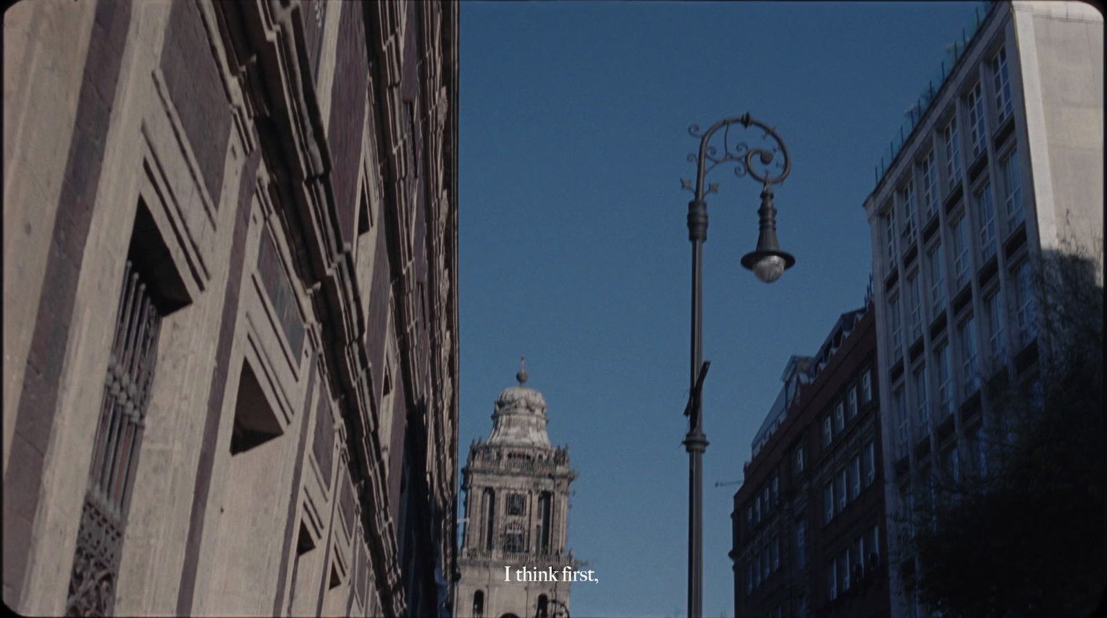 a street light next to a tall building