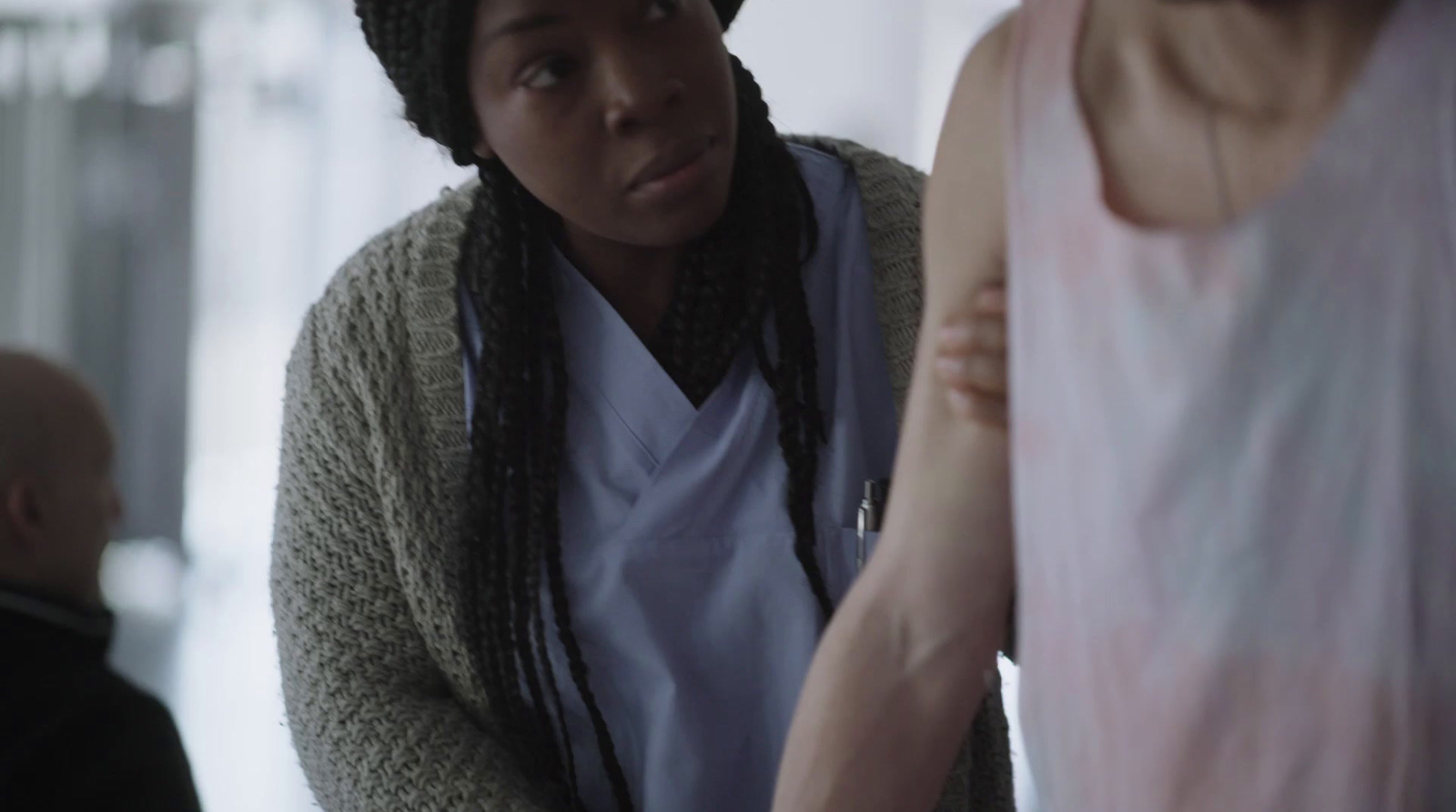 a woman standing next to another woman in a room