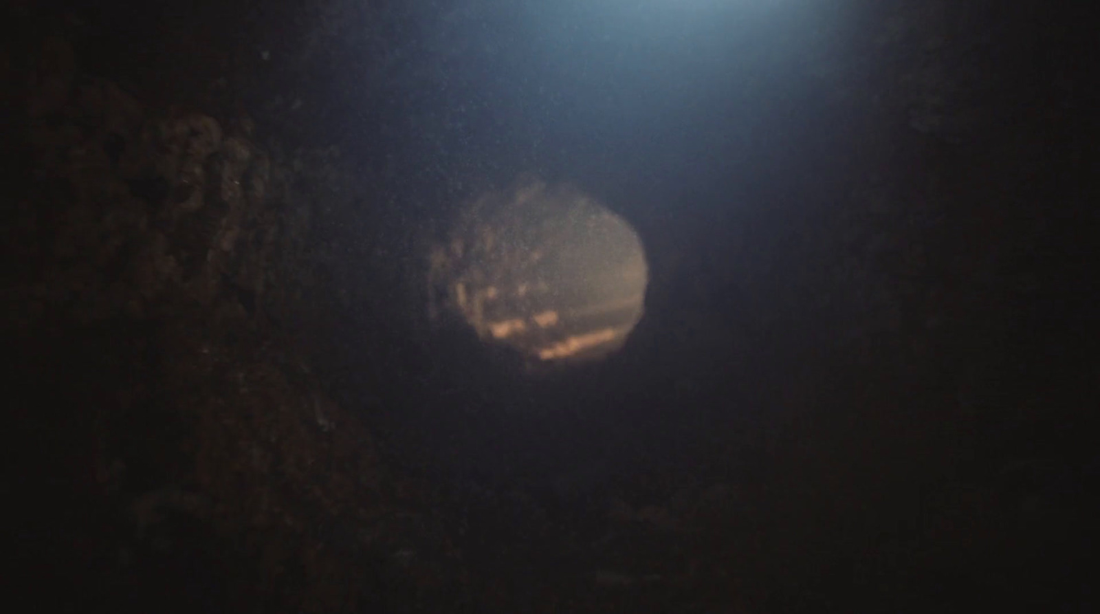 a light shines through a dark cave