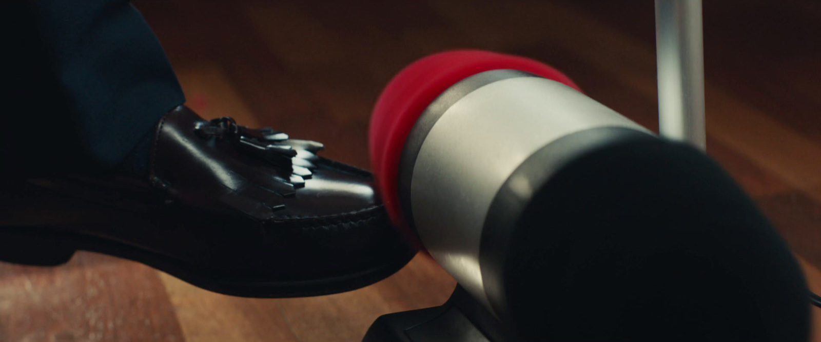 a close up of a person's shoes on a metal pole