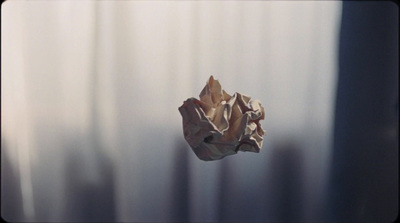 a crumpled piece of paper hanging from a curtain