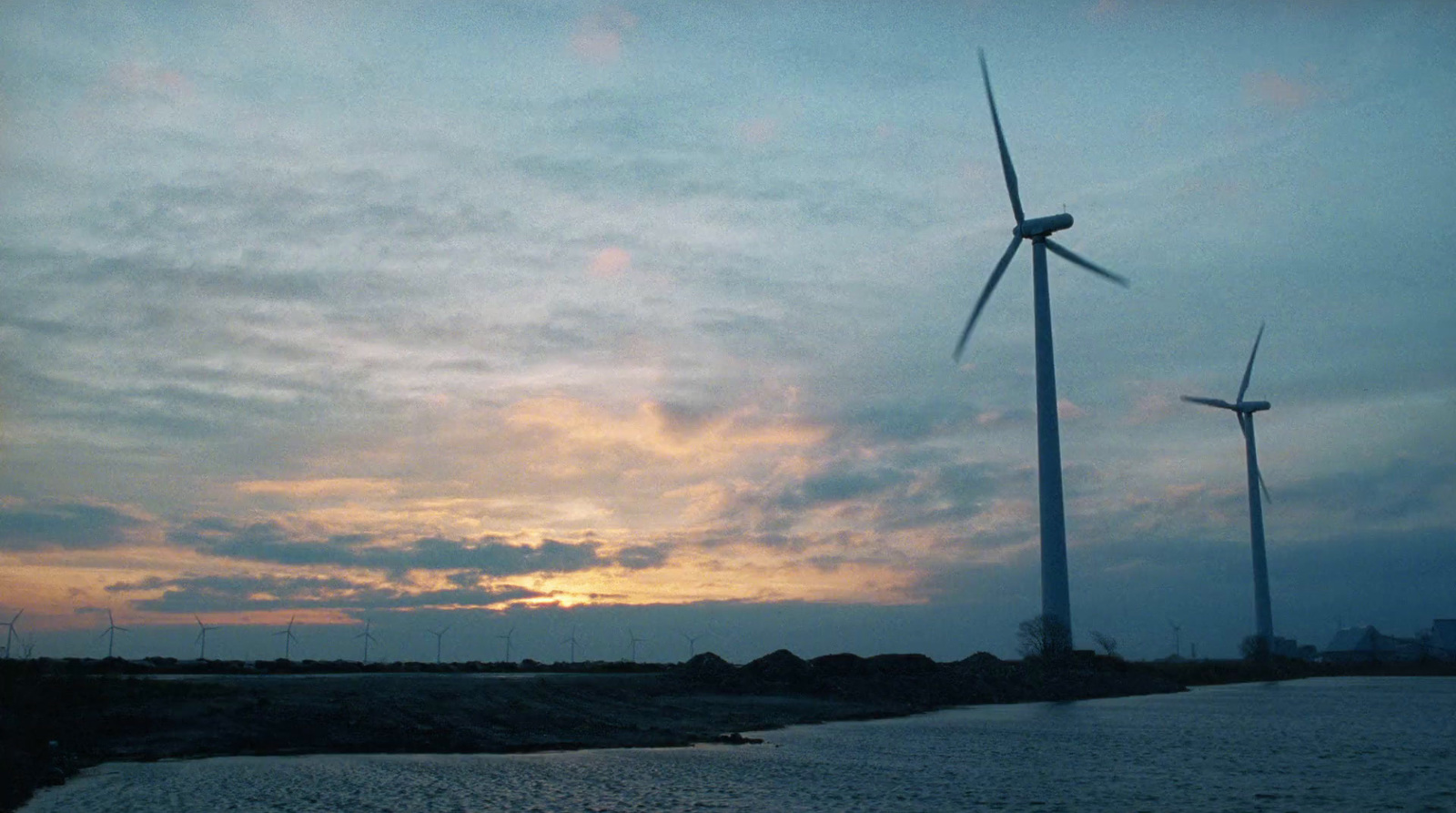 a couple of windmills that are standing in the dirt