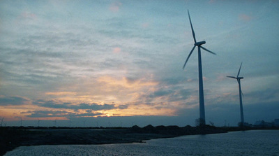 a couple of windmills that are standing in the dirt