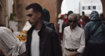 a group of people walking down a street next to each other