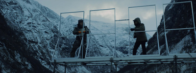 a couple of people standing on top of a bridge