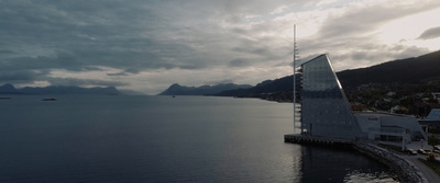 an aerial view of a building near a body of water