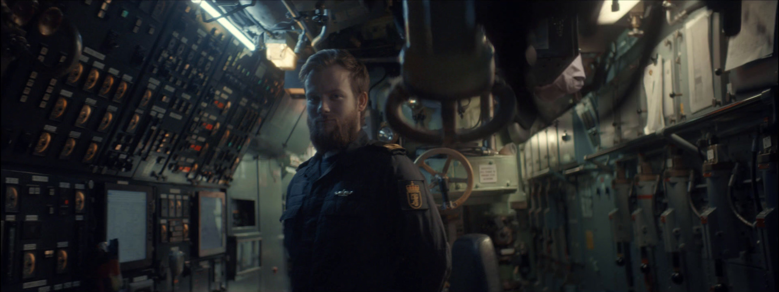 a man standing in a room filled with lots of electrical equipment