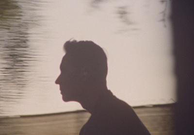 a man standing in front of a body of water