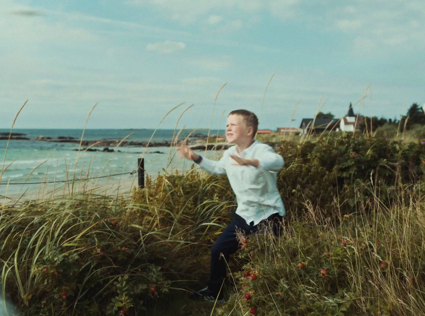 a man in a white shirt is throwing a frisbee