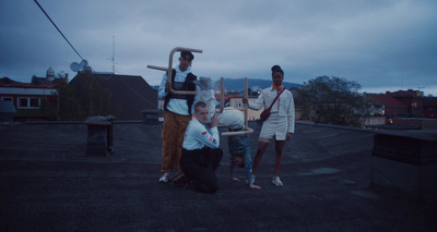 a group of people standing on top of a roof