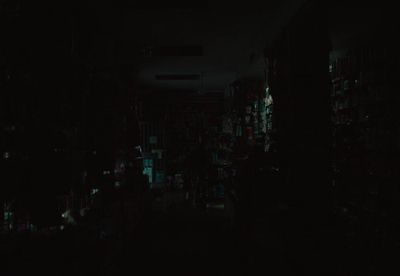 a dark room filled with lots of books