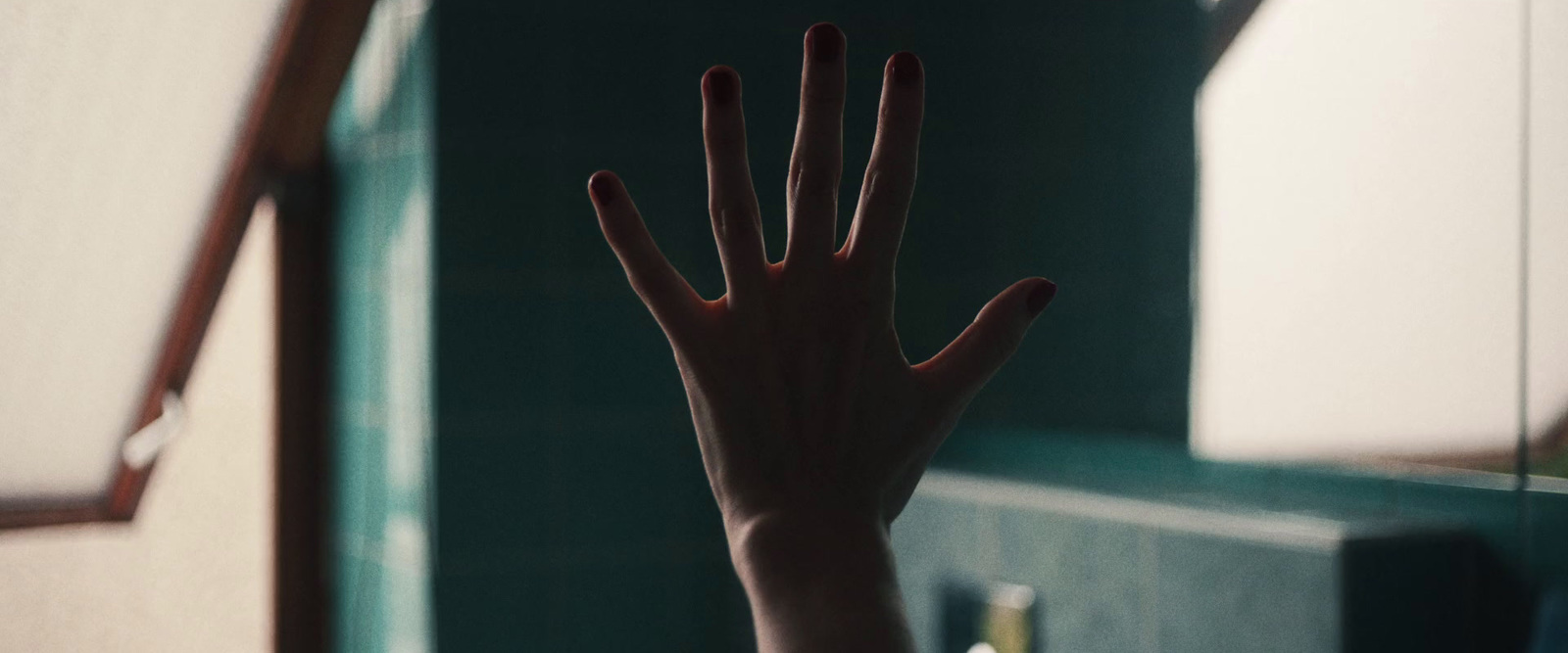 a person's hand reaching up into the air