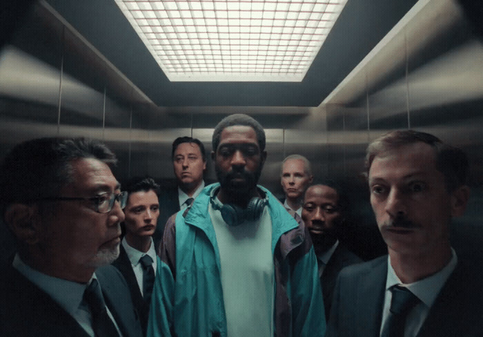 a group of men standing in a elevator