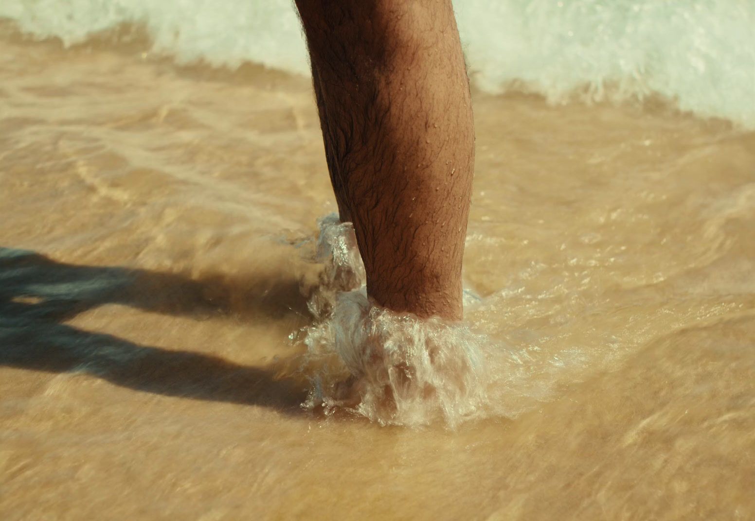 a person standing in the water at the beach