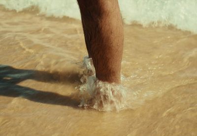 a person standing in the water at the beach