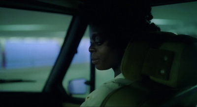 a woman sitting in a car looking out the window