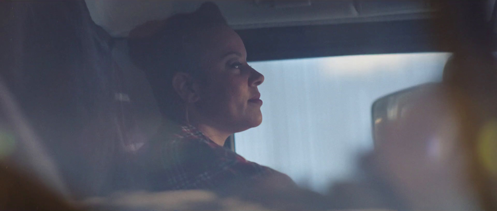 a woman sitting in the back seat of a car