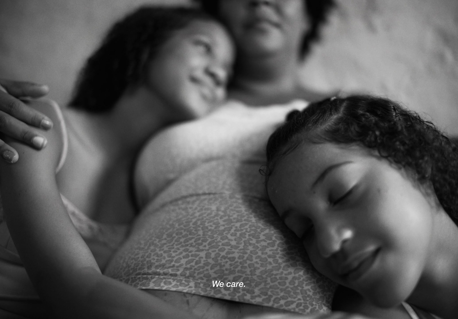 a black and white photo of two women sleeping