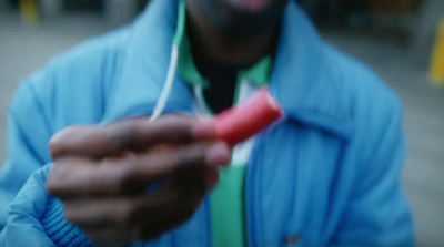 a man in a blue jacket is holding a toothbrush