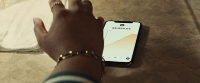 a person holding a cell phone on a table