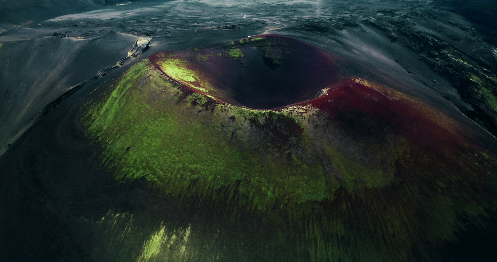 an aerial view of a crater in the ocean