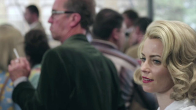 a woman standing next to a man in a crowd of people