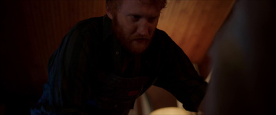 a man in a dark room looking at a computer screen