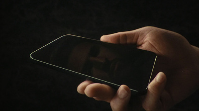 a person holding a cell phone in their hand