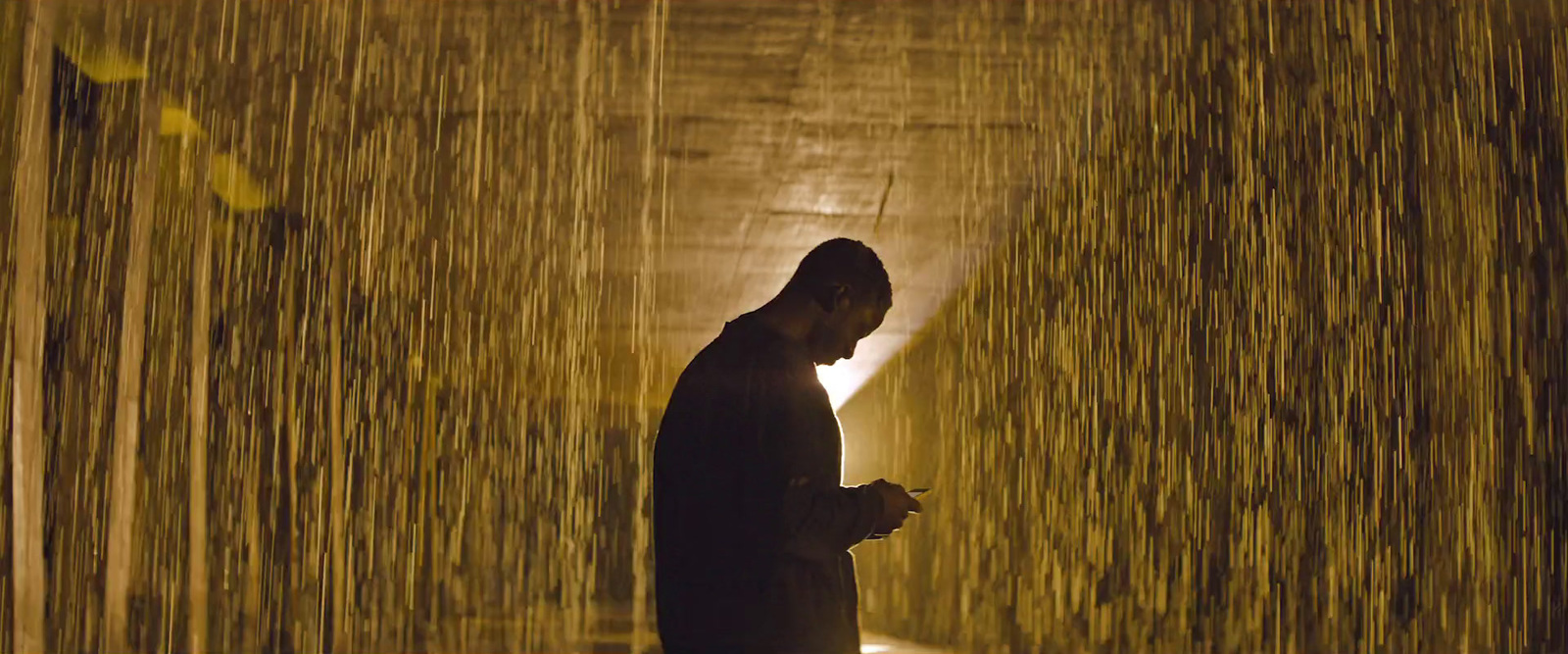 a man standing in front of a wall of water