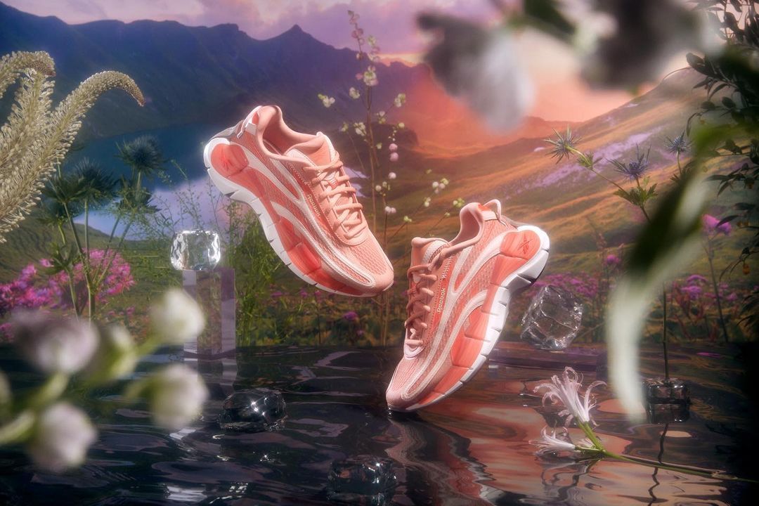 a pair of pink sneakers floating on top of a body of water