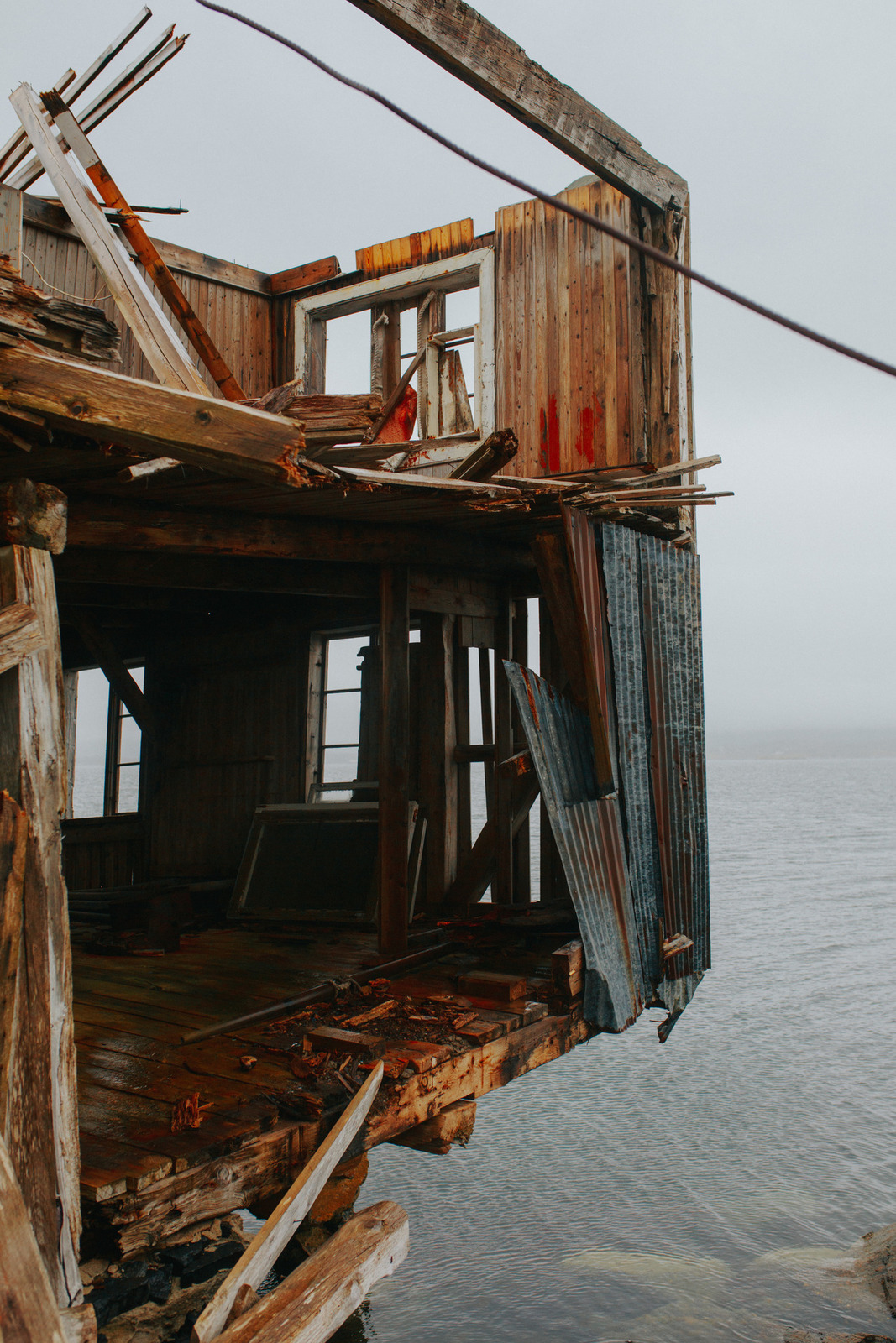 an old wooden building with a broken window