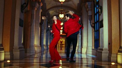 a man and a woman dancing in a hallway