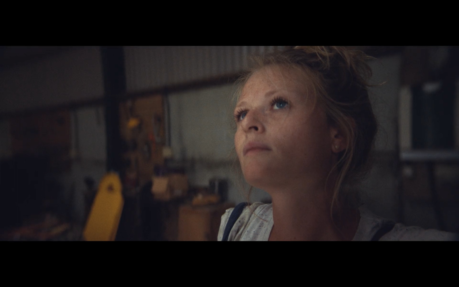 a woman looking up in a garage