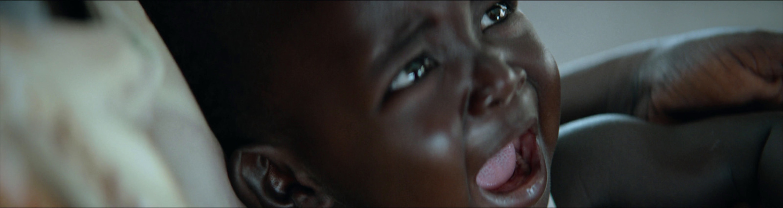 a close up of a child's face with a blurry background