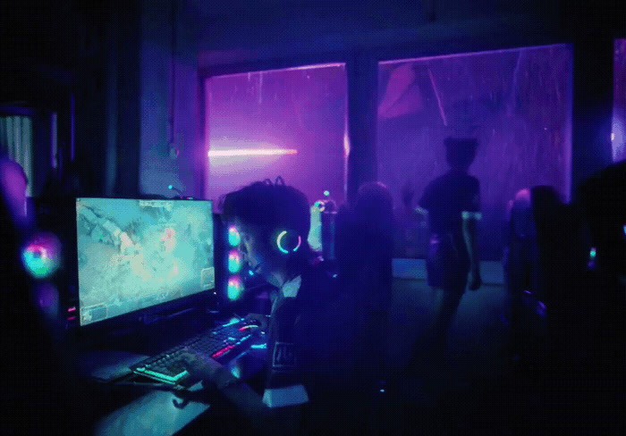 a group of people in a dark room playing a video game