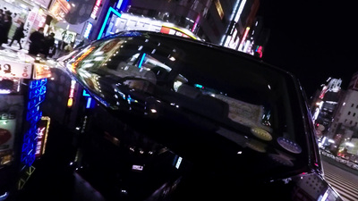 a car driving down a city street at night