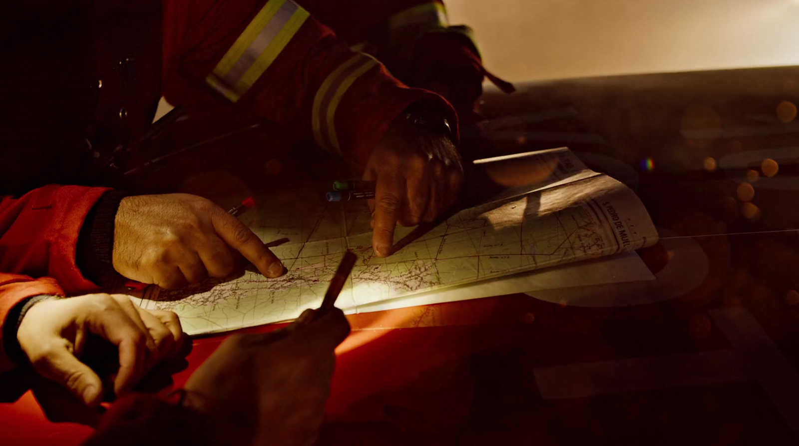 a man in a fireman's uniform writing on a piece of paper