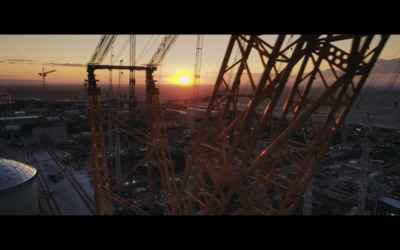 the sun is setting over a construction site