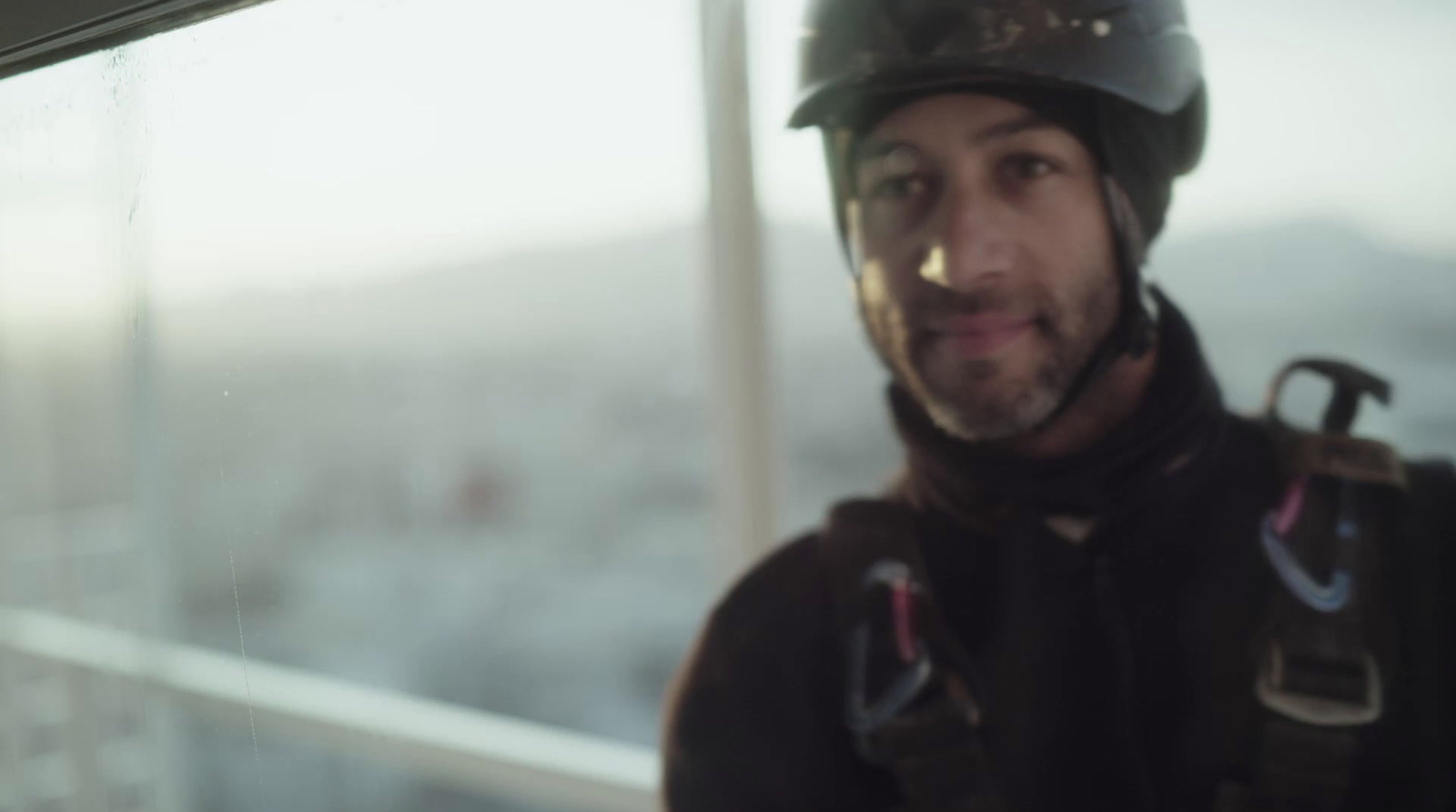 a man wearing a helmet and holding a pair of ski poles