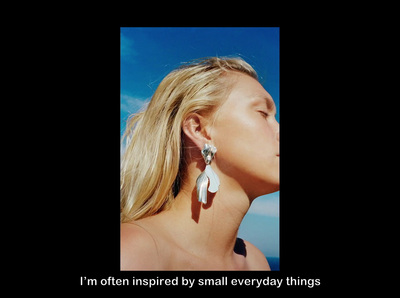 a woman wearing a pair of earrings with the words i'm often inspired by