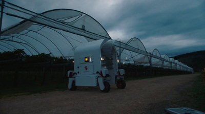 a large white machine sitting in the middle of a field